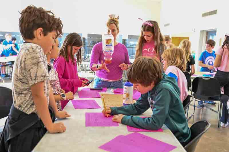 Students use bottle flipping to demonstrate statistical probability at progressive school.