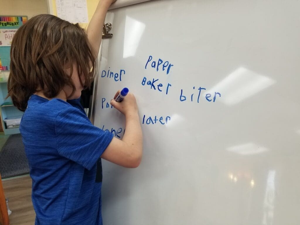 Student practices -er words at homeschool coop.